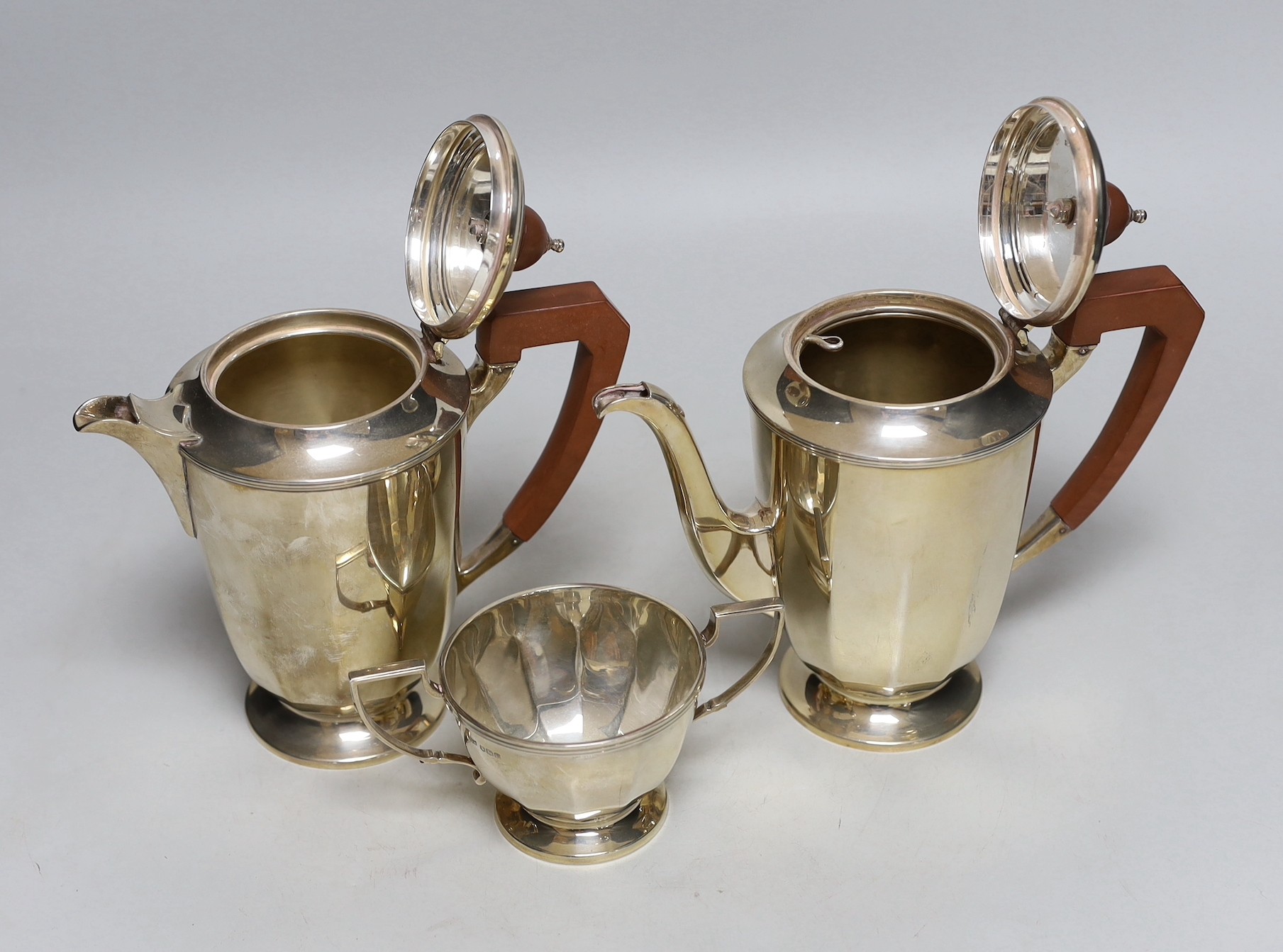A George VI panelled silver coffee pot, hot water pot and sugar bowl by Mappin & Webb, Sheffield, 1947, gross weight 30.9oz.